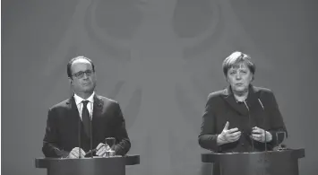  ?? AGENCE FRANCE PRESSE ?? German chancellor Angela Merkel and French President Francois Hollande attend a press conference at the chanceller­y in Berlin.