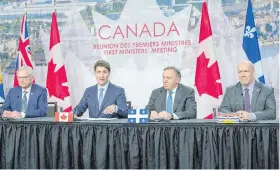  ?? RYAN REMIORZ, THE CANADIAN PRESS ?? New Brunswick Premier Blaine Higgs, left, Prime Minister Justin Trudeau, Quebec Premier Francois Legault and B.C. Premier John Horgan speak to reporters at the first ministers meeting Friday in Montreal.