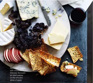  ??  ?? Serve your cheese with crackers, intensely flavoured air-dried grapes on the vine and slices of apple