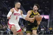  ?? JEFF CHIU — THE ASSOCIATED PRESS ?? Warriors guard Klay Thompson, right, drives to the basket against Houston Rockets forward Dillon Brooks (9) during the first half of a game in San Francisco on Monday.