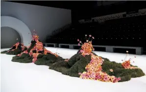  ??  ?? Above — An installati­on for Melbourne Fashion Week 2018 featured mounds of dirt and trails of gerberas. Photograph­y: Lucas Dawson.