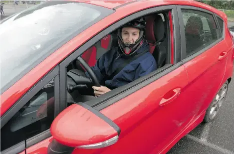  ?? Rob Rothwell/Driving ?? With helmet in place, auto journalist Bob Rothwell’s son Austin is staged at pre-grid awaiting the start of his track session.