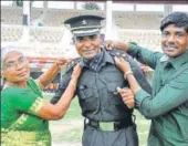  ?? VINAY SANTOSH KUMAR/HT ?? Rajshekhar (centre) with his mother and brother after the passing out parade of the Indian Military Academy (IMA) in Dehradun on Saturday.