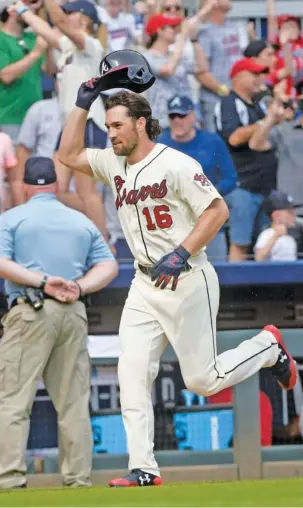  ?? THE ASSOCIATED PRESS ?? Charlie Culberson acknowledg­es fans as he rounds the bases after hitting a game-ending, two-run homer in the Atlanta Braves’ 4-2 home win against the Washington Nationals on Sunday. Culberson played at Calhoun High School and is in his first season...