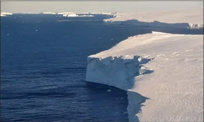  ?? (AP/British Antarctic Survey/David Vaughan) ?? (Left photo) This 2020 photo provided by the British Antarctic Survey shows the Thwaites glacier in Antarctica. Starting Thursday, a team of scientists are sailing to the massive but melting Thwaites glacier, “the place in the world that’s the hardest to get to,” so they can better figure out how much and how fast seas will rise because of global warming eating away at Antarctica’s ice. (Above photo) A hole is visible in the Thwaites glacier in Antarctica.