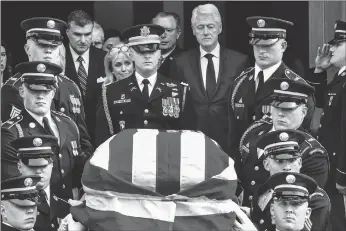  ?? Washington Post photo by Bill O’leary ?? An honor guard carries the casket of Rep. John Dingell from Holy Trinity church in Washington, followed by his widow, Debbie Dingell, rear left, and former President Bill Clinton, right, after funeral services.