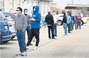  ?? NATHAN DENETTE THE CANADIAN PRESS ?? Front-line workers at generic drug giant Apotex line up to get COVID-19 vaccinatio­ns through a mobile clinic set up by Humber River Hospital on April 9. A second clinic was held Thursday.