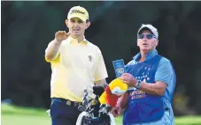  ?? Picture: GETTY IMAGES ?? Greg Chalmers talks with his caddie on the 9th.