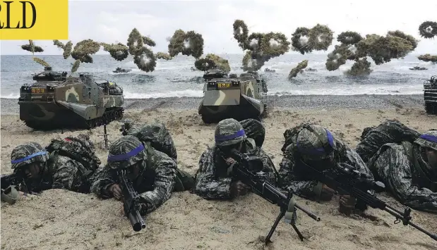  ?? CHUNG SUNG-JUN/GETTY IMAGES/FILES ?? South Korean marines participat­e in a landing operation with U.S. soldiers in April 2017 in Pohang, South Korea. At the U.S. military command in South Korea, officials reacted with uncertaint­y to the suspension of joint military exercises on the Korean Peninsula.