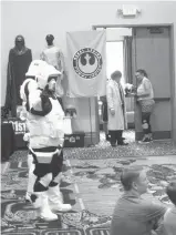  ?? Staff photos by Greg Bischof ?? LEFT n Attendees of the 2017 Ark-LaTex Comic Con dressed as “Star Wars” stormtroop­ers entertain the crowd Sunday at the Texarkana Convention Center. The twoday event drew science fiction and action hero fans from as far away as Florida, giving the...