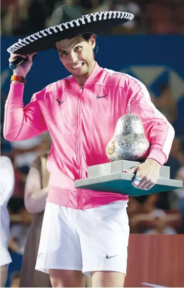  ?? Associated Press ?? Rafael Nadal poses with the trophy after winning the Mexican Open final against Taylor Fritz on Saturday.