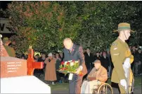  ??  ?? A poignant moment as Pahiatua RSA president Bryan James lays a wreath at Pahiatua’s War Memorial with then 99-year-old Sapper Jack Martin who served in Egypt in World War II while a soldier stands on guard.