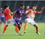  ?? SRENG MENG SRUN ?? Nagaworld’s Soung Virak (centre) chases the ball under pressure from opposition players yesterday.