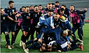  ??  ?? Scotland players celebrate after qualifying for the Euro 2020. — Reuters