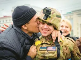  ?? EFREM LUKATSKY/AP ?? A resident welcomes a Ukrainian soldier Sunday in central Kherson. Russia’s retreat marked a triumphant milestone in Ukraine’s pushback against the Feb. 24 invasion.