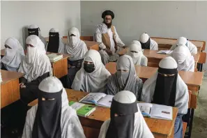  ?? The Associated Press ?? ■ Afghan girls attend a religious school, which has remained open since last year’s Taliban takeover, on Thursday in Kabul, Afghanista­n.