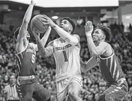  ?? Brad Tollefson / AP ?? Texas Tech's Brandone Francis (1) powers his way to the basket between Iowa State's Lindell Wigginton (5) and George Conditt IV during the first half of Wednesday night’s game in Lubbock.