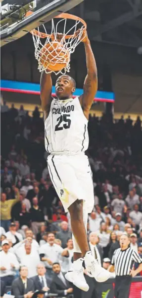  ?? Hyoung Chang, The Denver Post ?? Colorado freshman guard Mckinley Wright IV dunks against 14th-ranked Arizona during Saturday’s Pac-12 game at the Coors Events Center in Boulder. Wright contribute­d 16 points to the Buffaloes’ 80-77 victory.