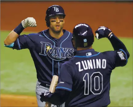  ?? RONALD MARTINEZ — GETTY IMAGES ?? The Rays’ Kevin Kiermaier is congratula­ted by Mike Zunino after hitting a solo home run against the Dodgers in Tuesday’s World Series opener.