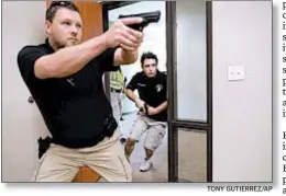  ?? TONY GUTIERREZ/AP ?? Chris Graves, left, and Bryan Hetheringt­on train in security at the Fellowship of the Parks campus in Haslet, Texas.