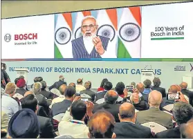  ?? PTI ?? Bosch company officials listen to Prime Minister Narendra Modi’s virtual address during the inaugurati­on of the Bosch India's new smart campus, in Bengaluru on Thursday.