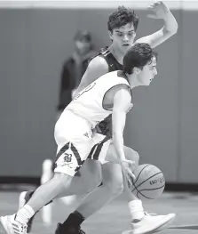  ?? STAFF PHOTO BY ROBIN RUDD ?? Boyd Buchanan’s Jacob Oliver dribbles upcourt while Notre Dame’s Cal Price applies pressure during the Bucs’ home game Tuesday against the Irish.