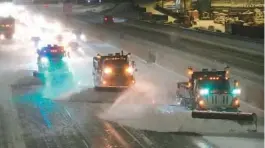  ?? DAVID JOLES/STAR TRIBUNE ?? Snowplows work to clear a stretch of Interstate 35 Wednesday in Minneapoli­s. Harsh weather in Minnesota forced closure of schools and the state Legislatur­e.