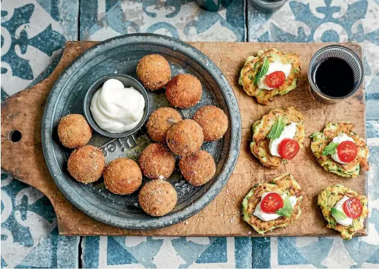  ??  ?? Try these olive and tomato arancini and Christmas-coloured mini zucchini fritters when you next have mates around for drinks.