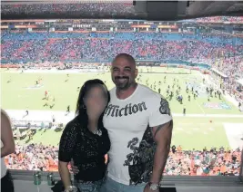  ?? Courtesy of Mary Fowler ?? David Coriaty poses with his ex-wife inside Hawk’s suite at the Miami Dolphins’ stadium. Coriaty took investors to games until Hawk lost its tickets for lack of payment.