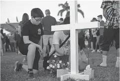  ?? XAVIER MASCARENAS/ TREASURE COAST NEWS ?? Zachary Valdes, 13, attends a candleligh­t vigil in Parkland, Fla., a day after the mass shooting at Marjory Stoneman Douglas High School.