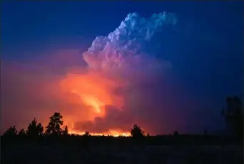  ?? John Hendricks/Oregon Office of State Fire Marshal via AP ?? Flames and smoke rise from the Bootleg Fire in southern Oregon on Wednesday. The lightning-caused fire was encroachin­g on the traditiona­l territory of the Klamath Tribes, which still have treaty rights to hunt and fish on the land.