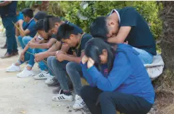  ?? YERANIA ROLON/AP ?? People pray for brothers Yovani and Jair Valencia Olivares and their cousin Misael Olivares Monterde on Thursday in the village of San Marcos Atexquilap­an, Mexico.