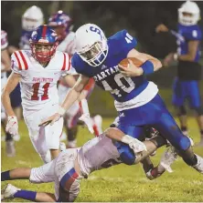  ?? STAFF PHOTOS BY NICOLAUS CZARNECKI ?? TOUGH TO STOP: Stoneham’s Jonathan Neal is taken down by Burlington’s Ryan O’Halloran during last night’s game; below, Deshaun Chase has room to run in Stoneham’s 44-14 victory.