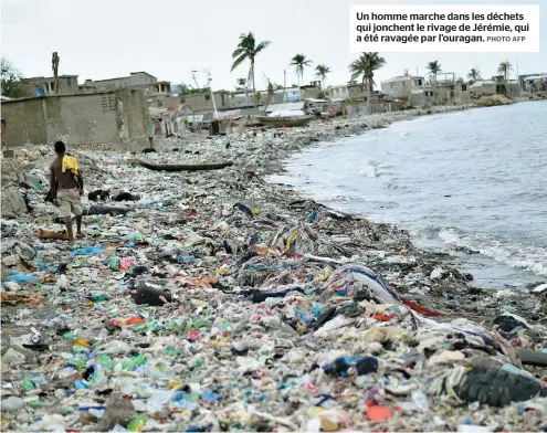  ??  ?? Un homme marche dans les déchets qui jonchent le rivage de Jérémie, qui a été ravagée par l’ouragan.
