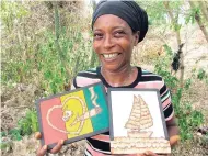  ?? PHOTO BY PAUL H. WILLIAMS ?? Opal Lowe-Rowe of Newell, St Elizabeth, displays two of her wall plaques with images made of cigarette tailpapers.