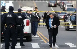  ?? (AP/John Minchillo) ?? New York Police Department officers work Sunday outside the agency’s 41st Precinct, where a gunman wounded an officer in the station house. More photos at arkansason­line.com/210nypd/.