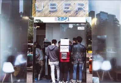  ?? JUSTIN CHIN / BLOOMBERG ?? Applicants turn up at one of Uber’s offices during a driver recruitmen­t exercise in Hong Kong. According to a Reuters report, more than 1 million of Hong Kong’s 7.3 million residents have downloaded the Uber app so far, while tens of thousands have registered as drivers.