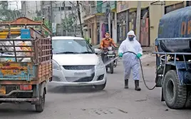  ?? — DEEPAK DESHPANDE ?? A disaster rescue team of the GHMC sprays disinfecta­nt in a colony near Mallepally in a bid to combat Covid-19.