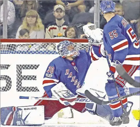  ?? GETTY ?? After getting pulled in previous game, Henrik Lundqvist catches on to help Rangers to first victory of the season.