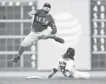  ?? Jon Shapley / Houston Chronicle ?? Rangers second baseman Rougned Odor completes a throw to first for a double play after forcing Astros outfielder Colby Rasmus at second during the fifth inning. It was the only double play of the game.