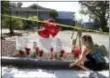  ?? CARLINE JEAN /SOUTH FLORIDA SUNSENTINE­L VIA AP, FILE ?? Janice Connelly of Hollywood sets up a makeshift memorial Thursday in memory of the senior citizens who died in the heat at The Rehabilita­tion Center at Hollywood Hills, Fla. Multiple people died and patients had to be moved out of the facility, many...