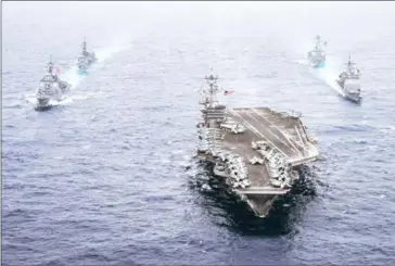  ?? US NAVY/SEAN CASTELLANO/AFP ?? The aircraft carrier USS seen here on Wednesday, is now ‘in striking range’ of North Korea. The US has said it is looking to bring the hermit country back to the negotiatin­g table.