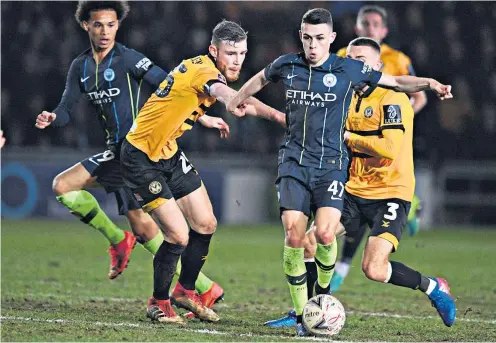  ??  ?? Too hot to handle: Manchester City midfielder Phil Foden, who scored twice, puts the Newport defence under pressure at Rodney Parade