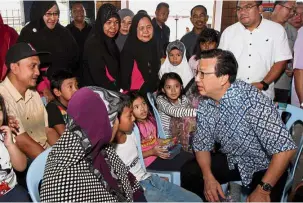  ??  ?? Friendly chat: Liow speaking to residents after attending a senior citizens’ celebratio­n in Kampung Teroh, Bentong.