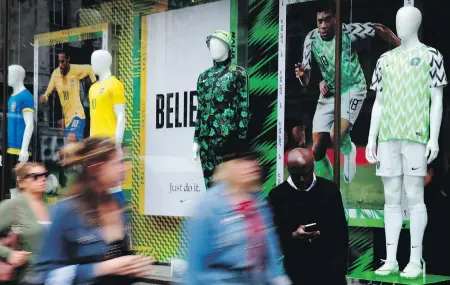  ??  ?? National soccer team jerseys of Nigeria and Brazil are on display at a shop in London. With the FIFA World Cup set to start, some winners and losers have emerged among the designs of the jerseys to be worn by the 32 teams.