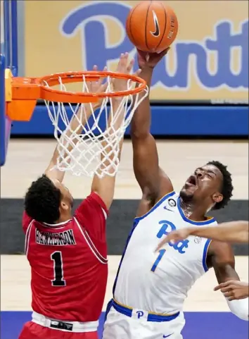  ?? Matt Freed/Post-Gazette photos ?? Pitt’s Xavier Johnson drives to the basket against Northern Illinois guard Trendon Hankerson Saturday night in the first half at Petersen Events Center. Johnson was one of four players in double figures as the Panthers defeated the Huskies, 89-59.