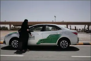  ?? AP/NARIMAN EL-MOFTY ?? Driving instructor Mabkhoutah al-Mari stands next to a test drivers car over the weekend at the Saudi Driving School inside Princess Nora University in Saudi Arabia.