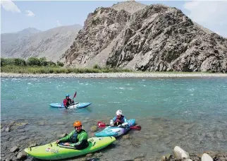  ??  ?? Three foreign tourists kayak along the Panjshir River in Panjshir province, north of capital Kabul, as excited children and bemused police lined the banks of the fast-flowing river on a recent sunny morning.