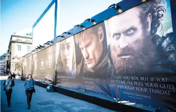  ??  ?? People walk past an advertisin­g poster to promote the HBO’s ‘Game of Thrones’ outside the Internatio­nal Game of Thrones exhibition in Stockholm on Mar 11, 2015. — AFP file photo