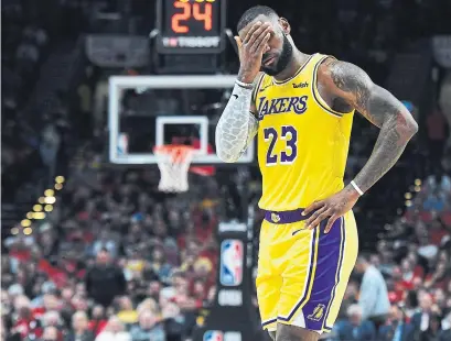  ?? STEVE DYKES GETTY IMAGES ?? LeBron James and the Los Angeles Lakers missed their first 15 three-point attempts in a season-opening loss to the Blazers.